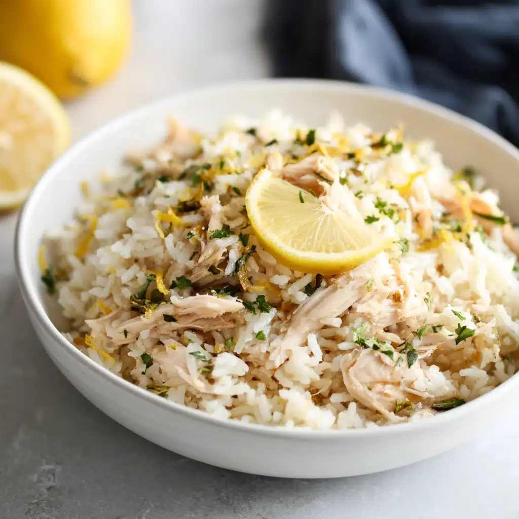 Bowl of Slow Cooker Lemon Herb Chicken and Rice with lemon zest and herbs.